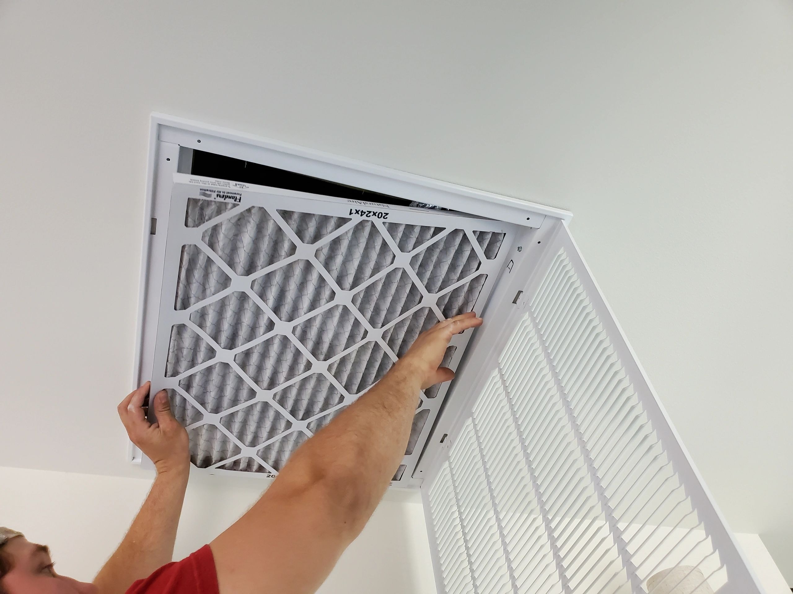 HVAC technician installing air filter